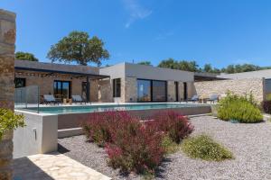 an exterior view of a house with a swimming pool at Theros Estate in Amfilochia
