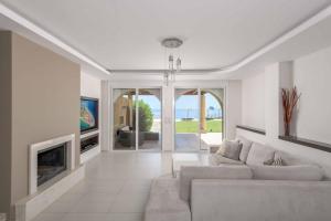 a living room with a couch and a fireplace at Paradise Beach II in Kiotari