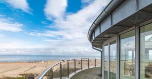 a balcony with a view of the beach at Strand-Hotel Hübner in Warnemünde