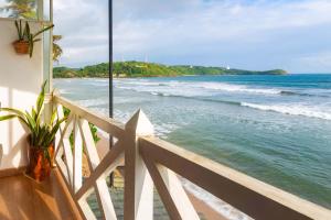 a view of the beach from a balcony at Villa Surf Beach in Galle