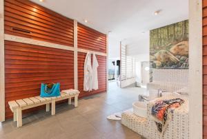 a bathroom with a wooden accent wall and a wall at Strand-Hotel Hübner in Warnemünde