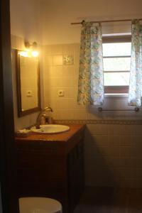 a bathroom with a sink and a toilet and a window at Casa RioTempo + Jangada in Tomar +85 photos