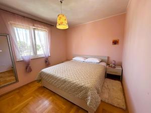 a bedroom with a bed and a window at Apartment Second Home in Tribunj