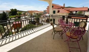 a balcony with chairs and a table on a balcony at Apartment Second Home in Tribunj +12 photos