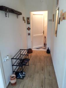 a hallway with a white door and a wooden floor at Apartman Tanja Trebinje in Hrupjela +14 photos