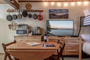 a kitchen with a table and a television and a bed at Mother Nature's Inn in Tahoe City