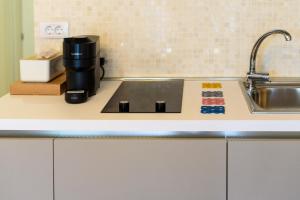 a kitchen counter with a sink and a coffee maker at Astria Amalfi - Complex Novum in Olimp +62 photos