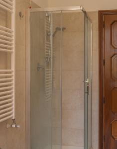 a shower with a glass door in a bathroom at Villa Rosa in Castiglione del Lago
