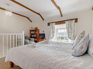 a bedroom with a large white bed with a window at 1 Bed in Portreath PENNA in Carnbrea