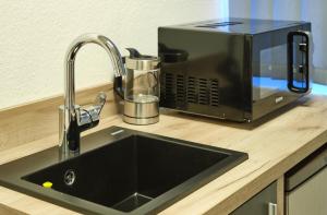 a kitchen counter with a sink and a toaster at sleep1c in Hamburg +10 photos