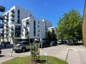 a parking lot with cars parked in front of a building at Kooli in Pärnu
