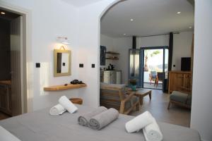 a bedroom with a bed with towels on it at White Dream Suites Antiparos in Antiparos