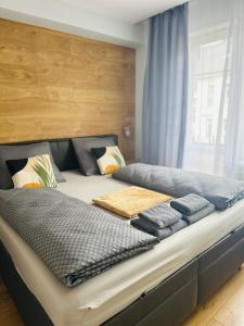 a large bed with two pillows on top of it at Apartment Rebeka in Ružomberok