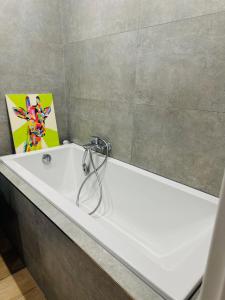 a white bath tub in a bathroom with at Apartment Rebeka in Ružomberok +20 photos