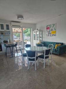 a living room with a glass table and chairs at Villa MirIva in Katuni