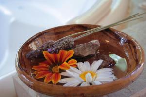 a bowl with flowers in it with a pair of chopsticks at Al Sereno Hotel Spa in Tilcara +40 photos