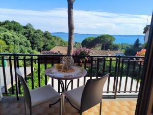 a table and chairs on a balcony with a view at La perla di Trevignano in Trevignano Romano