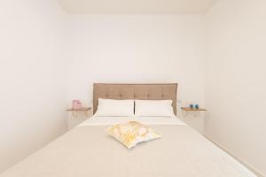 A bed or beds in a room at Quattro Perle