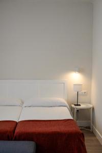 Postel nebo postele na pokoji v ubytování Hostal Jakiton