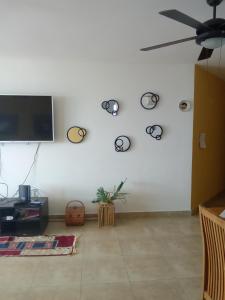 a living room with a flat screen tv on a white wall at Terrazas 3 habitaciones EDF terrazas white beach Río Hato in Río Hato