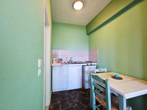 a small kitchen with a table and a sink at Ocea Retreat in Karlovasi +31 photos