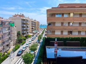 a view of a street with parked cars and buildings at Palm Beach by Unik Vacation in La Pineda