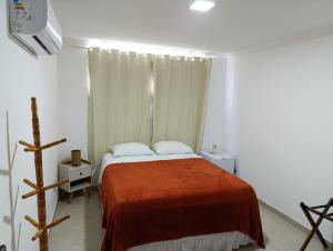 a bedroom with a bed with a red blanket at Pousada Espaco Luz do Sol Beira-Mar in João Pessoa +45 photos