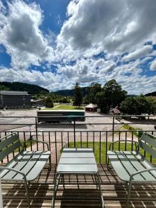 a group of chairs sitting on top of a balcony at La Perle de l'Eau - au bord du lac in Gérardmer