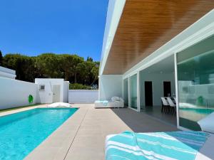 a house with a swimming pool in front of it at Chalét El Nirvana in Chiclana de la Frontera