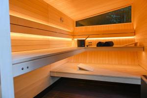a sauna with a bench in the middle at Sleep Space 22 - Green Tiny Village Harz in Osterode