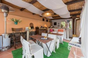 a dining room with wooden tables and white chairs at Villa Mariella Pittorino - camere in B&B in Leni
