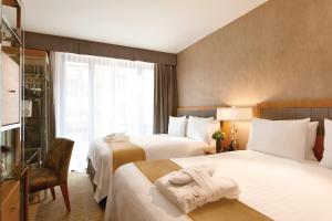 Postel nebo postele na pokoji v ubytování Executive Hotel Le Soleil New York