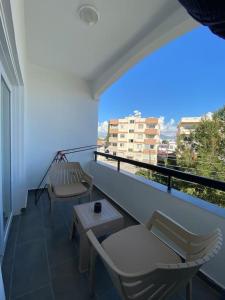 a balcony with two chairs and a table and a window at New renovated 1 BEDROOM FLAT North NİCOSİA 5A in Yenişehir