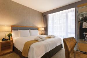 Postel nebo postele na pokoji v ubytování Executive Hotel Le Soleil New York
