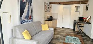 a living room with a couch and a table at La Perle du Port in Vannes