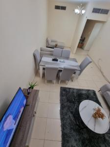 a living room with a couch and a table at Suit Appartment - Ajman in Ajman  +17 photos