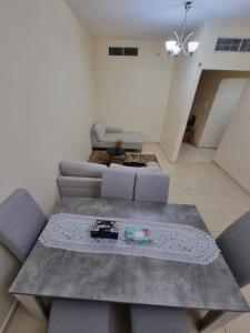 a living room with a couch and a table at Suit Appartment - Ajman in Ajman 