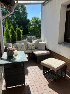 a patio with a couch and a table at Ferienwohnung Rosi in Bad Sachsa