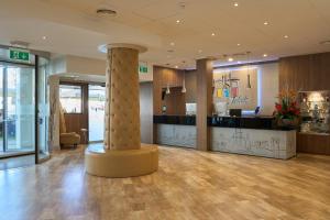 a lobby with a column in the middle of a building at Hotel Puerta de Toledo in Madrid