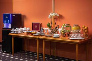 a table with plates and vases on top of it at Verdi Budapest Aquincum in Budapest