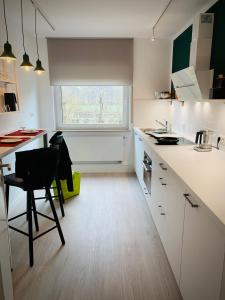 a white kitchen with a table and a window at 4-Studios in Cölbe