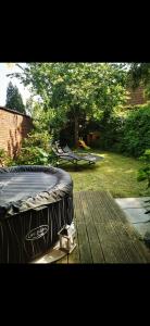 a mattress sitting on a table in a backyard at Grande maison tout confort, billard et spa -en saison in Lys-lez Lannoy