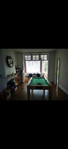 a living room with a pool table in it at Grande maison tout confort, billard et spa -en saison in Lys-lez Lannoy