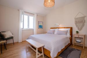 a bedroom with a large bed and a table at Holiday House Dolin in Rab +45 photos