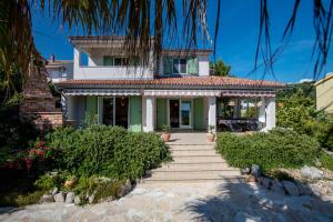 a house with a staircase in front of it at Holiday House Dolin in Rab