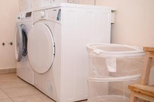 a white washer and dryer in a room at Holiday House Dolin in Rab