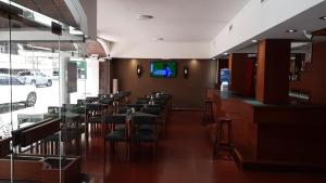 a restaurant with a row of tables and chairs at Hotel Perugia in Necochea