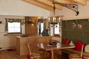 a kitchen with a wooden table and a dining room at Burgchalet in Reutte