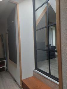 a mirror on a wall next to a living room at Na Sopie in Witów