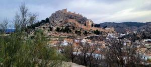 a mountain with a castle on top of it at Casa María in Moclín
